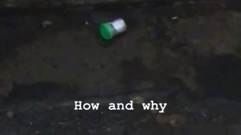 Urine sample green bottle in subway tracks