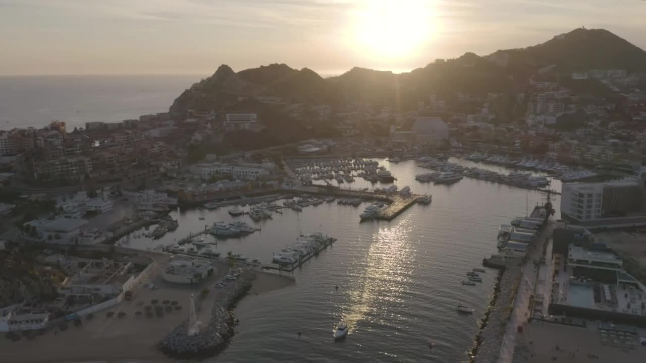 Aerial tour of a port at sunset