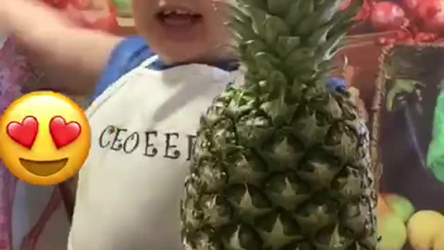 A child cutting fruit with his hands