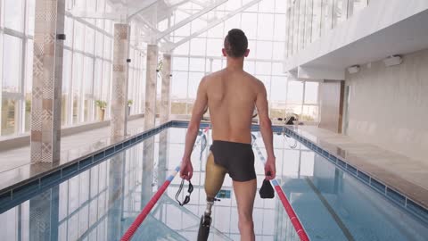 A One Legged Man Getting Ready To Dive On A Pool