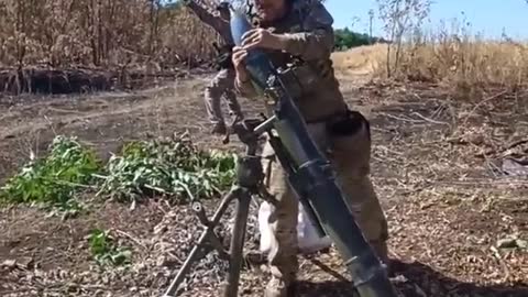 Ukrainian soldiers fire 120mm rounds towards Russian positions