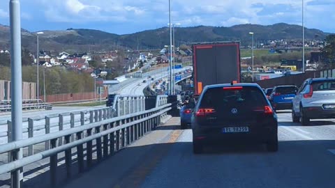 Person Drives Mobility Scooter Along Busy Roadway