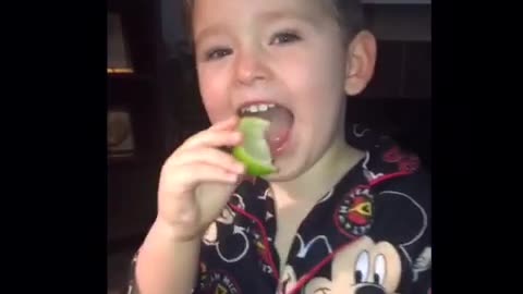 Little kid disney mickey mouse pajamas eats lime