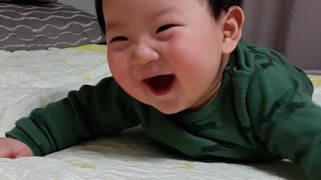 This is a very cute baby video with a bright smile.