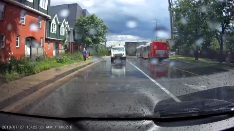 Driver Swerves into Puddle Splashing Pedestrian