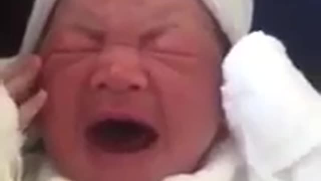 baby crying in father's arms