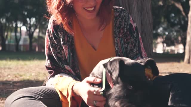 A Woman Petting Her Dog