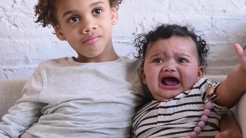 Brothers Sitting on Sofa Together Cry