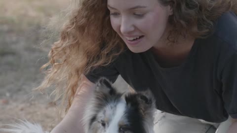 Woman having fun with her cute little puppy