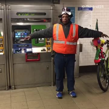 Man flaps his arms like a bird and makes bird noises in subway station