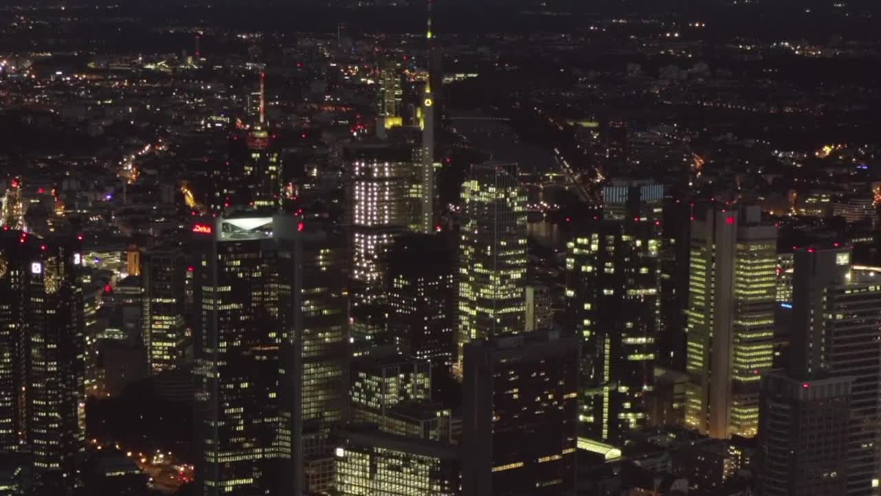 Frankfurt at night in the distance, aerial shot