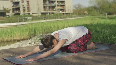 Young woman performing yoga pose outdoors