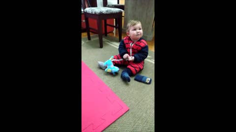 baby playing with his new toy dog