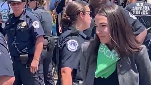 AOC has just been escorted by police away from the Supreme Court