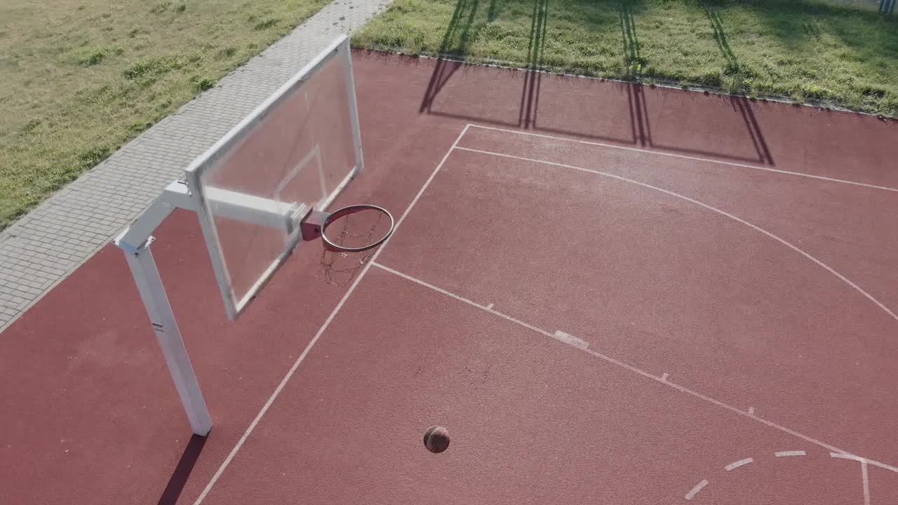 A Basketball Player Shooting The Ball In A Reverse Layup