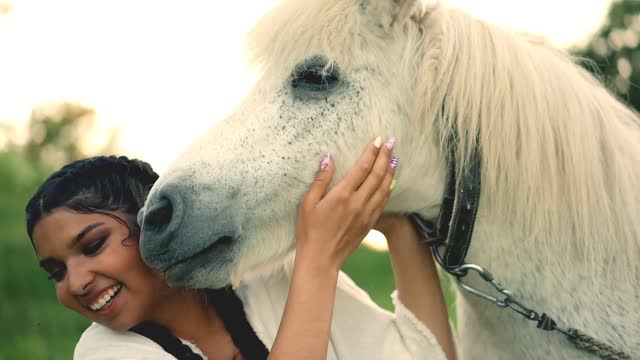 A horse licks a woman's face And he's loving it too