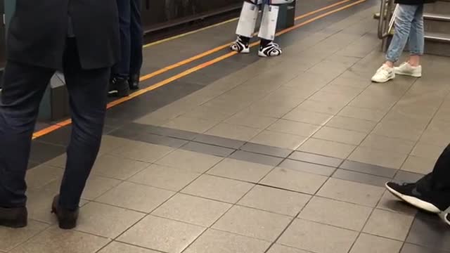 Robot transformers costume made out of beer boxes subway platform