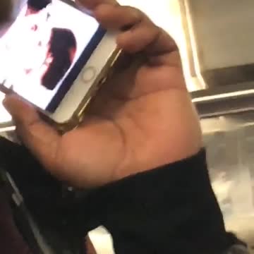 Guy pretending to be on phone but has video opened on his phone