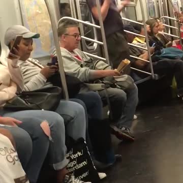 Man red ear phones jumping in subway train