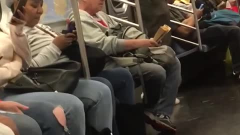 Man red ear phones jumping in subway train