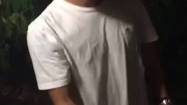 Guy with white t-shirt on fails at trying to crack a beer on his head