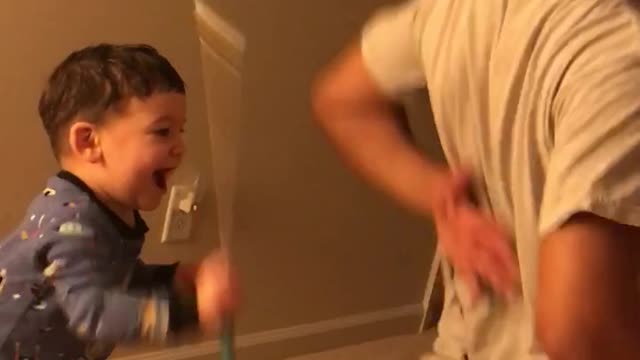 Toddler uses Back Scratcher