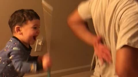 Toddler uses Back Scratcher