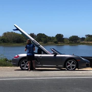 Surf board in grey silver convertible car