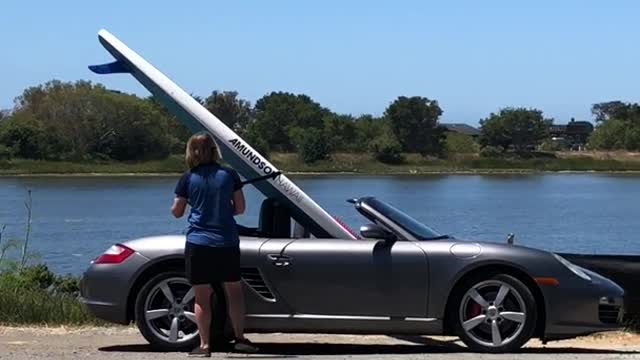 Surf board in grey silver convertible car