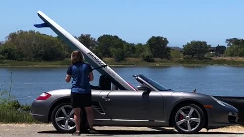 Surf board in grey silver convertible car