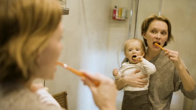 Toddler's adorable reaction of brushing with her mom