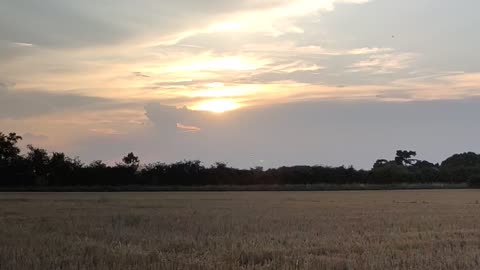 A sunset behind the clouds