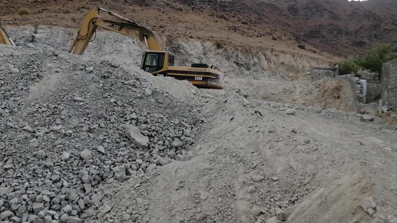 Excavator working in mountain