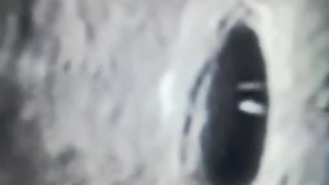 UFO entering the moon.