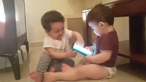 Two twins baby snatching phones.