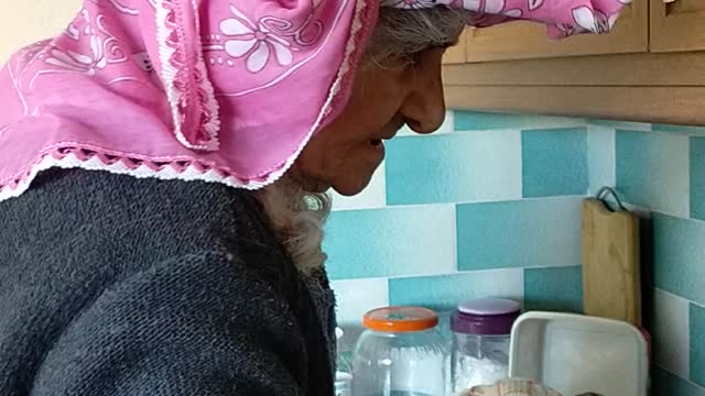 My lovely grandma washing dishes with scarf onahead