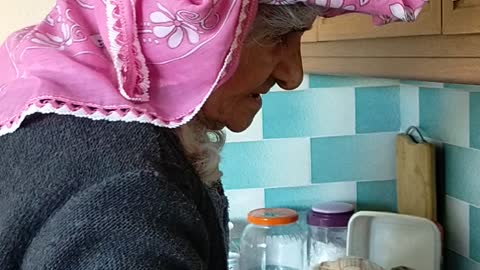 My lovely grandma washing dishes with scarf onahead