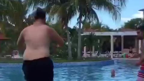 Guy slips into resort pool