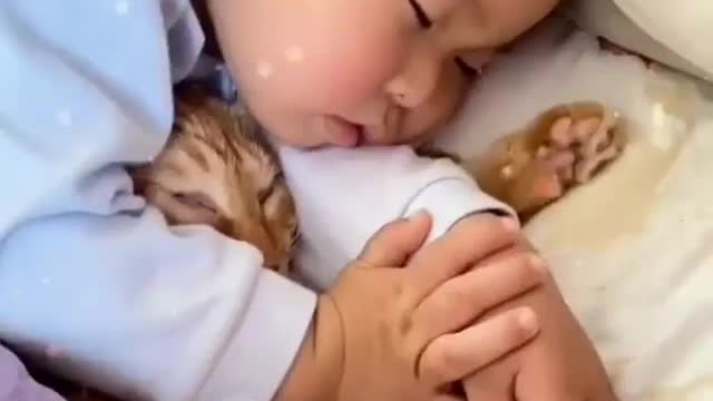 Cute baby and cat sleeping on bed