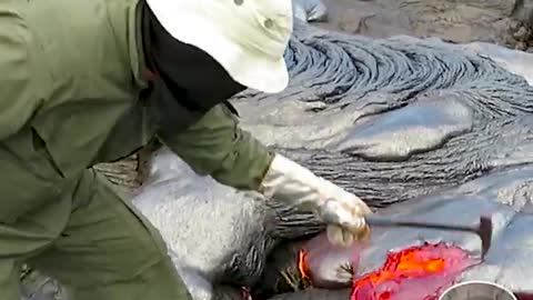 This is how geologists collect lava samples from an active volcano.