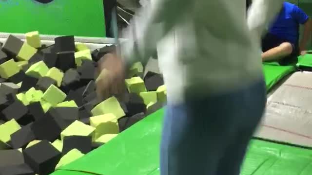 Guy slips and fails at green trampoline park