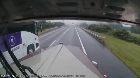 Reckless bus driver cuts off semi in the rain