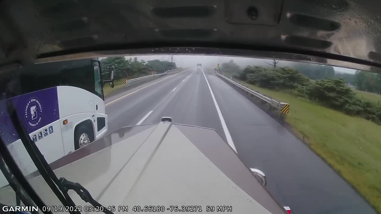 Reckless bus driver cuts off semi in the rain