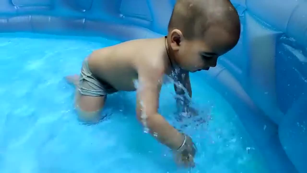 cute baby playing in bath tub