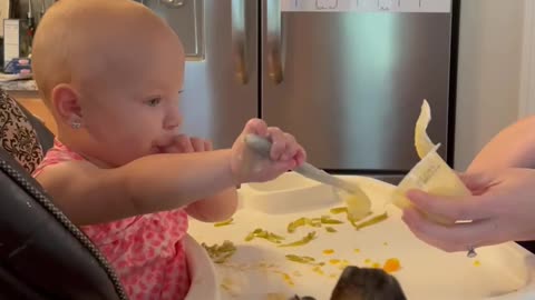 Baby loves sharing food with her puppy