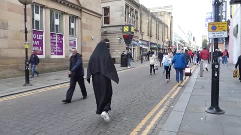 Men stroll in the street with terror masks