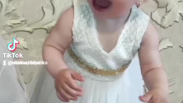 Cheerful little girl in a dress