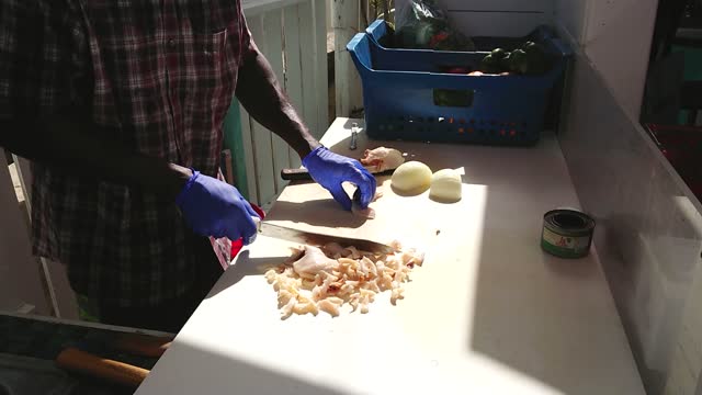 Man preparing conch for salad