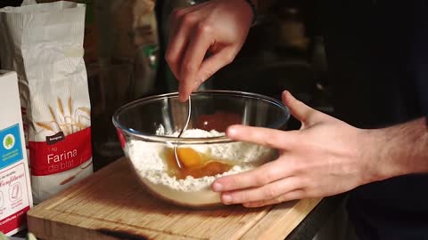 Stirring flour and eggs on a bowl