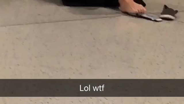 Girl in black sweater typing on phone with feet on floor